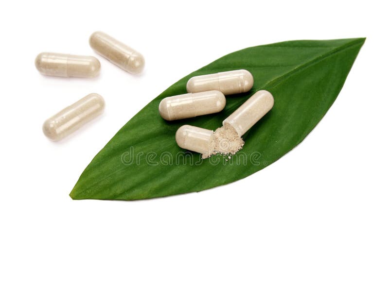 Natural pills and a green leaf. Natural pills and a green leaf