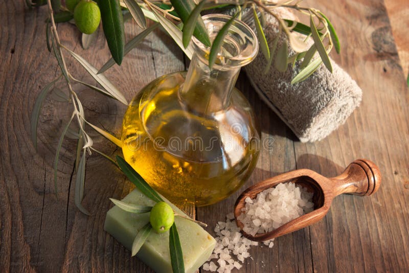 Natural spa setting with olive and olive oil products: bath salt, natural soap and olive oil. Natural spa setting with olive and olive oil products: bath salt, natural soap and olive oil.