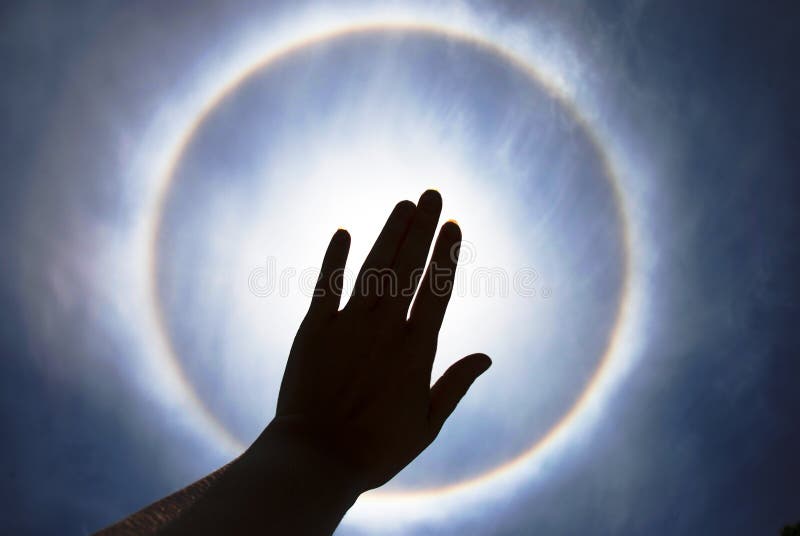 Ring around sun - natural phenomenon before storm, sky, eclipse, rainbow halo, hand. Ring around sun - natural phenomenon before storm, sky, eclipse, rainbow halo, hand