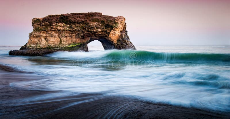 Sunset over Natural Bridges Beach Santa Cruz, Curling wave and sunset. Sunset over Natural Bridges Beach Santa Cruz, Curling wave and sunset.