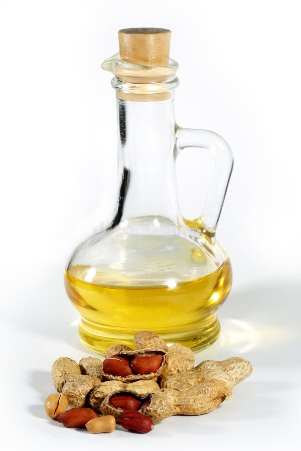 Peanut, nuts and oil in a glass carafe on the isolated background. Peanut, nuts and oil in a glass carafe on the isolated background