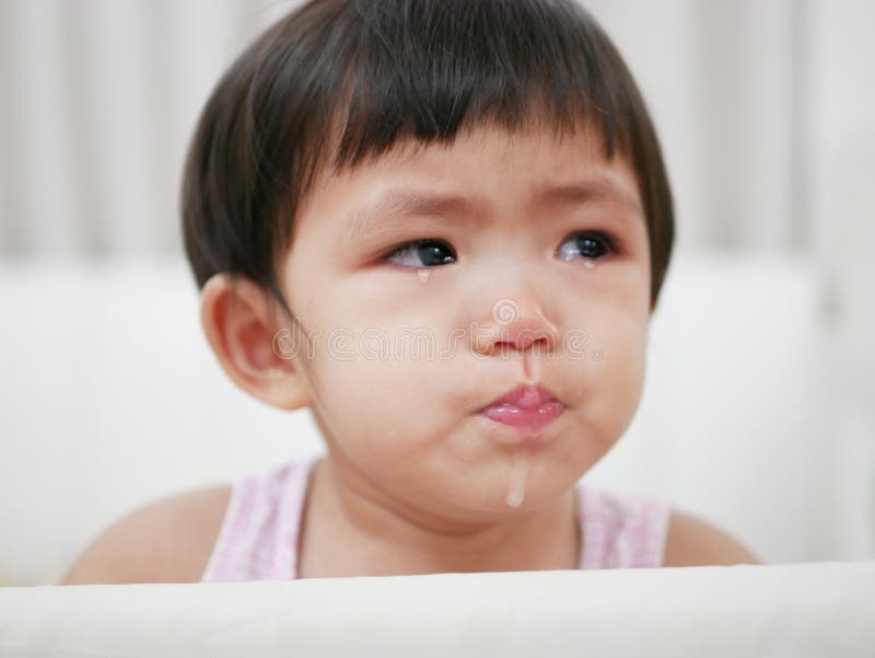 Crying and coughing Asian baby girl, 15 months old, with tears, as she doesn`t want to go to bed. Crying and coughing Asian baby girl, 15 months old, with tears, as she doesn`t want to go to bed