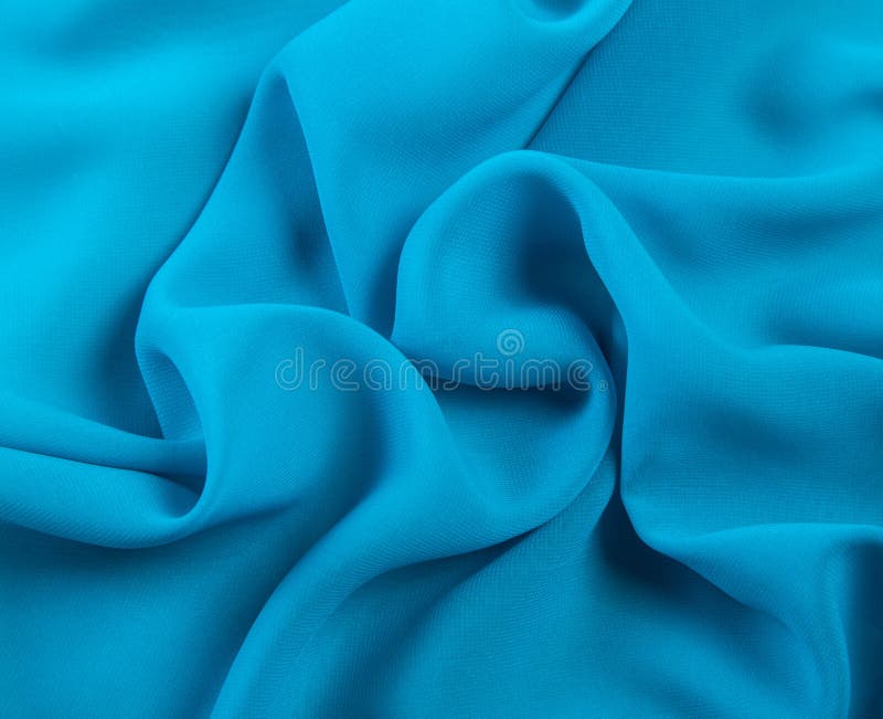 Bright draped blue chiffon fabric background. Bright draped blue chiffon fabric background