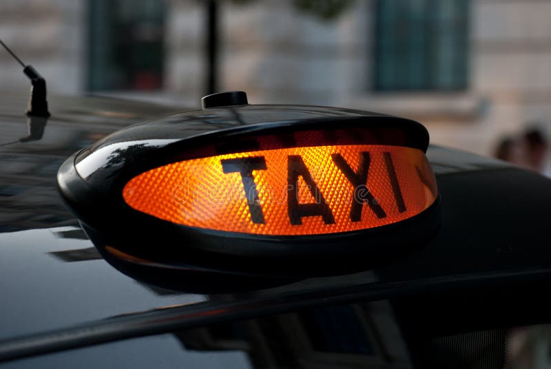 Illuminated London taxi sign, ready for hire. Illuminated London taxi sign, ready for hire.