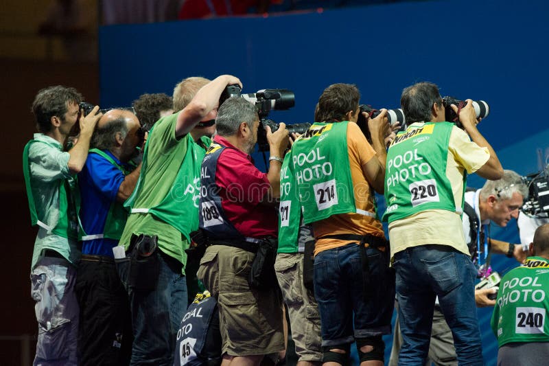 BARCELONA – AUGUST 1: Photographers in action during Barcelona FINA World Swimming Championships on August 1, 2013 in Barcelona, Spain. BARCELONA – AUGUST 1: Photographers in action during Barcelona FINA World Swimming Championships on August 1, 2013 in Barcelona, Spain