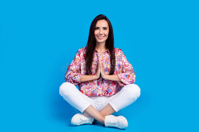 Full length photo of cute adorable lady dressed print shirt rpraying sitting legs crossed  blue color background. Full length photo of cute adorable lady dressed print shirt rpraying sitting legs crossed  blue color background.