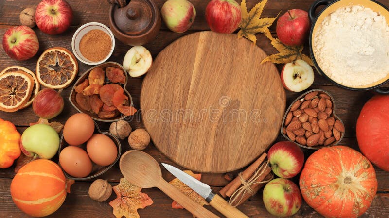 Kitchen background with ingredients for pumpkin and apple pies recipe, food preparation concept, cooking pies with spices, nuts, flour, eggs and pumpkin, apples for Thanksgiving, selective focus, top view, space for text. Kitchen background with ingredients for pumpkin and apple pies recipe, food preparation concept, cooking pies with spices, nuts, flour, eggs and pumpkin, apples for Thanksgiving, selective focus, top view, space for text