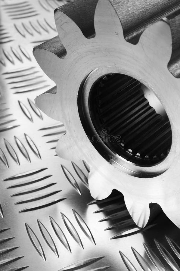 Large gear, cog on patterned stainless-steel. Large gear, cog on patterned stainless-steel