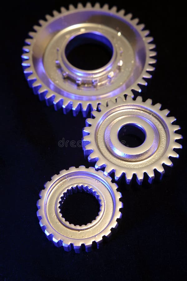 Three steel gears joining together. Three steel gears joining together