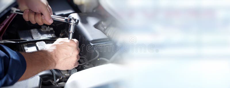 Hands of car mechanic with wrench in auto repair service. Hands of car mechanic with wrench in auto repair service.