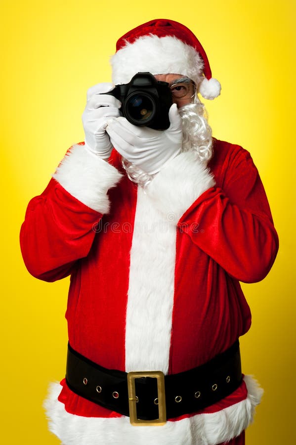 Χαμόγελο παρακαλώ! Santa που συλλαμβάνει ένα τέλειο πλαίσιο στοκ φωτογραφία με δικαίωμα ελεύθερης χρήσης Χαμόγελο παρακαλώ! Santa που συλλαμβάνει ένα τέλειο πλαίσιο στοκ φωτογραφία με δικαίωμα ελεύθερης χρήσης