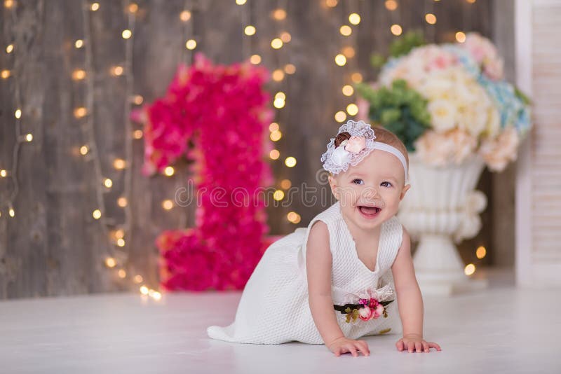 Cute baby girl 1-2 year old sitting on floor with pink balloons in room over white. Isolated. Birthday party. Celebration. Happy birthday baby, Little girl with group ball. Play room. Cute baby girl 1-2 year old sitting on floor with pink balloons in room over white. Isolated. Birthday party. Celebration. Happy birthday baby, Little girl with group ball. Play room