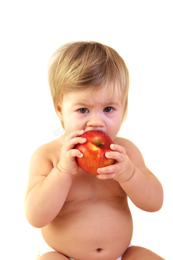 1 year old toddler eating apple isolated over white. 1 year old toddler eating apple isolated over white