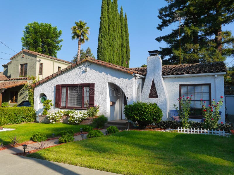 Stucco house with green lawn front yard adobe roof white  walls. Stucco house with green lawn front yard adobe roof white  walls