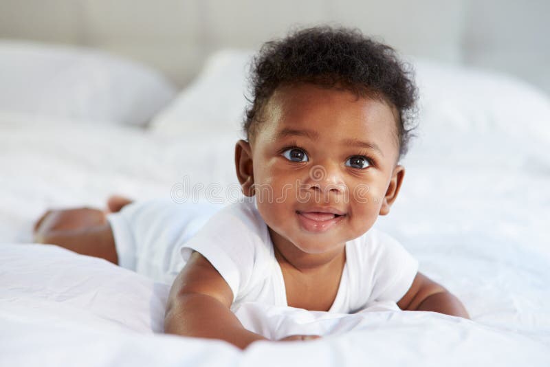 Cute Baby Lying On Tummy In Parent's Bed. Cute Baby Lying On Tummy In Parent's Bed