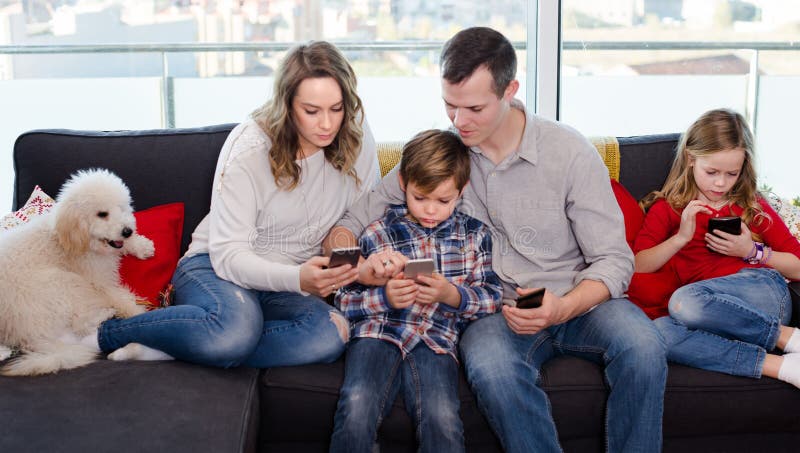 Happy parents with children spending time playing with smartphones at home. Happy parents with children spending time playing with smartphones at home