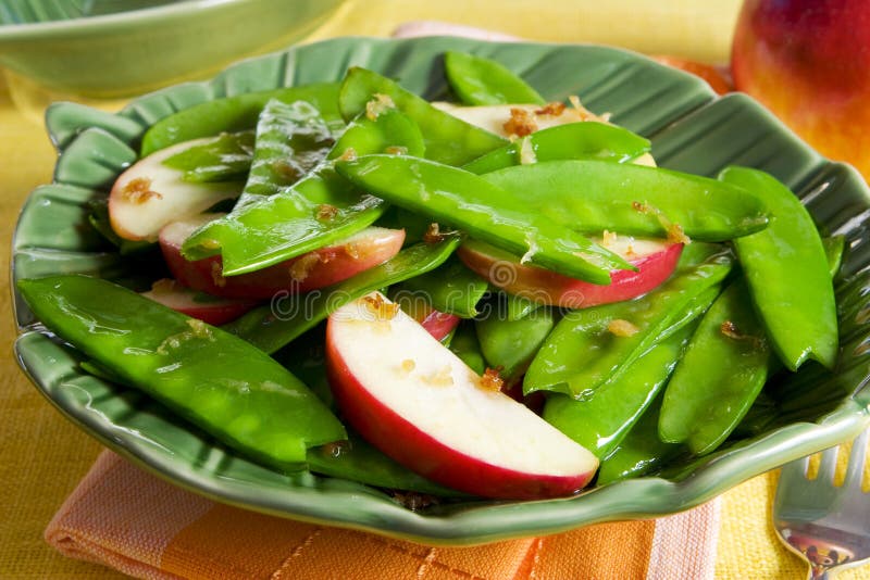 Snow peas and apples stir-fry with ginger and garlic. Snow peas and apples stir-fry with ginger and garlic