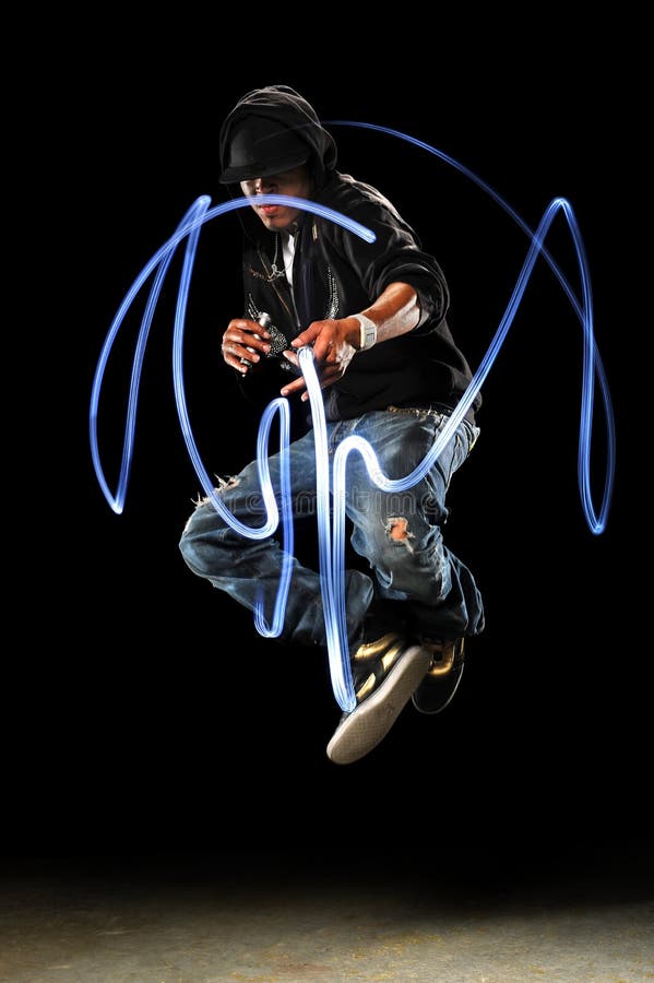 African American hip hop dancer with LED lights over dark background. African American hip hop dancer with LED lights over dark background