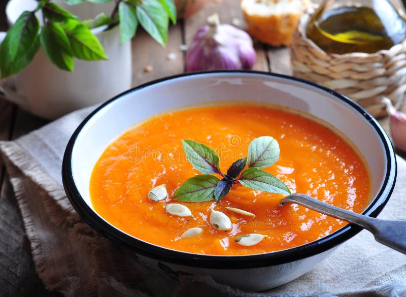 Vegetarian pumpkin soup with garlic, basil and olive oil, dinner. Vegetarian pumpkin soup with garlic, basil and olive oil, dinner