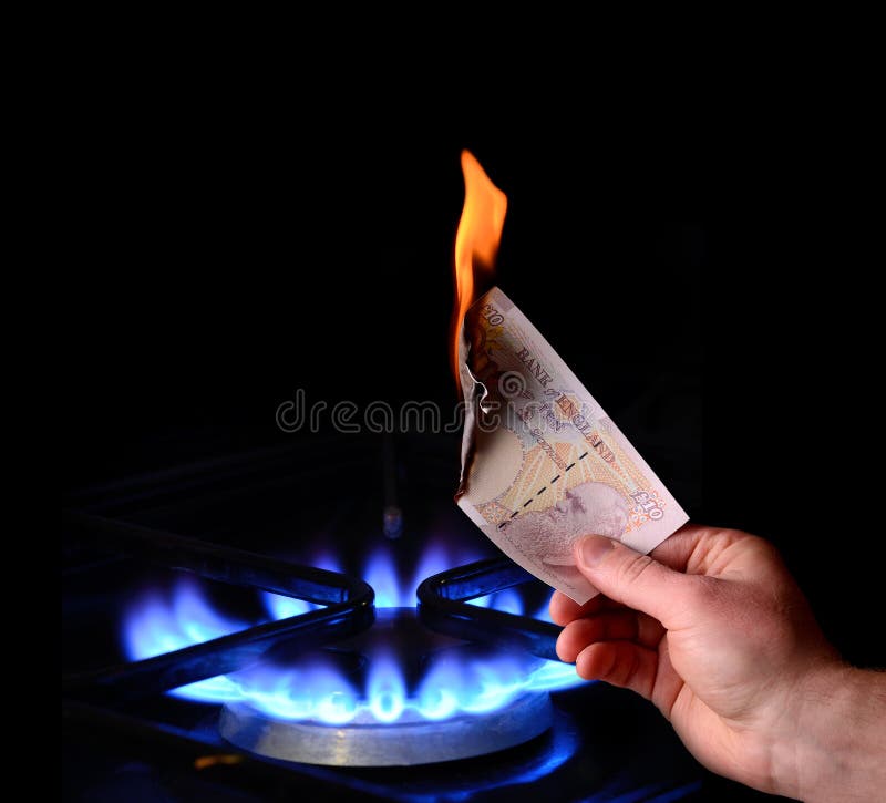 Money to burn! energy cost concept of burning a note on a gas fire. Money to burn! energy cost concept of burning a note on a gas fire
