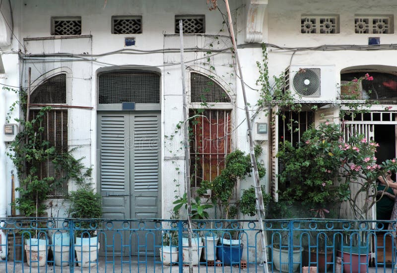 HO CHI MINH CITY, VIET NAM- JULY 09, 2019: Amazing scene of 100 years old residential area, row of old house with antique architecture, vintage color, rust iron railing of Chinese make China town. HO CHI MINH CITY, VIET NAM- JULY 09, 2019: Amazing scene of 100 years old residential area, row of old house with antique architecture, vintage color, rust iron railing of Chinese make China town