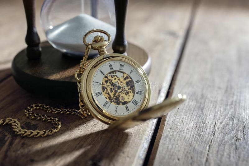 Vintage pocket watch and hour glass or sand timer, symbols of time with copy space. Vintage pocket watch and hour glass or sand timer, symbols of time with copy space