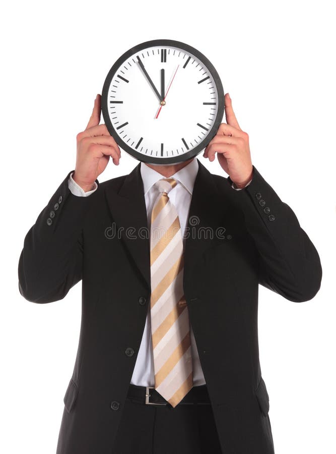 A businessman holding a clock that shows the elventh hour right in front of his face. All on white background. A businessman holding a clock that shows the elventh hour right in front of his face. All on white background.