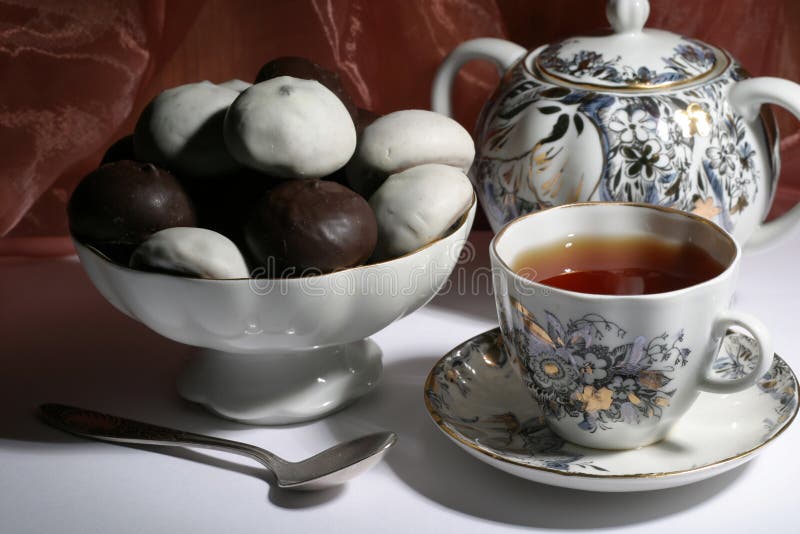 Cup of tea with teapot and cookies on the white table. Cup of tea with teapot and cookies on the white table