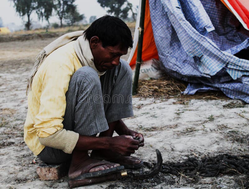 Photograph of a Asian Villager, who cilte fishes. Photograph of a Asian Villager, who cilte fishes.