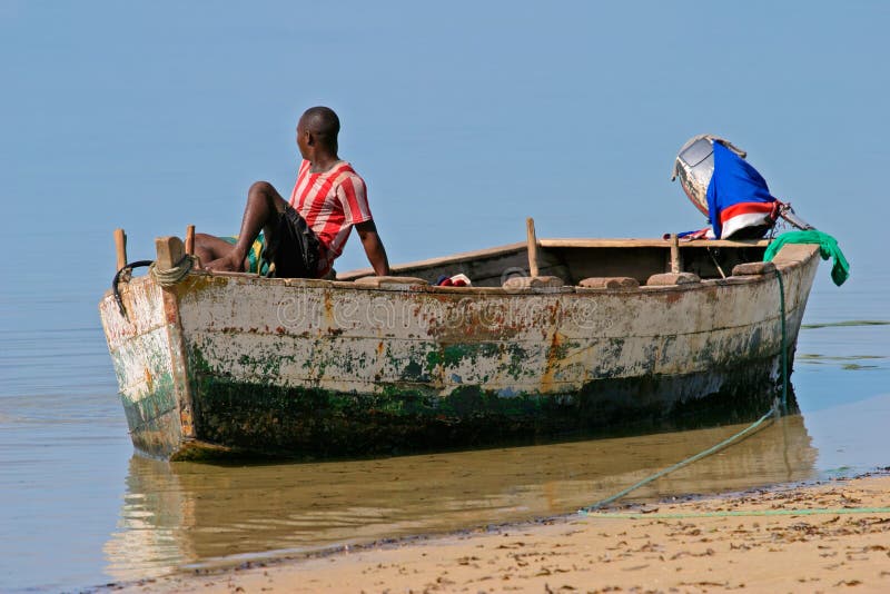 A mozambican fisherman sitting on a fishing boat. A mozambican fisherman sitting on a fishing boat