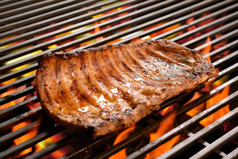 Grilled pork ribs/steak on the flaming grilled. Grilled pork ribs/steak on the flaming grilled