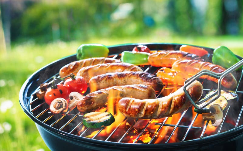 Grilled sausage on the picnic flaming grill. Grilled sausage on the picnic flaming grill