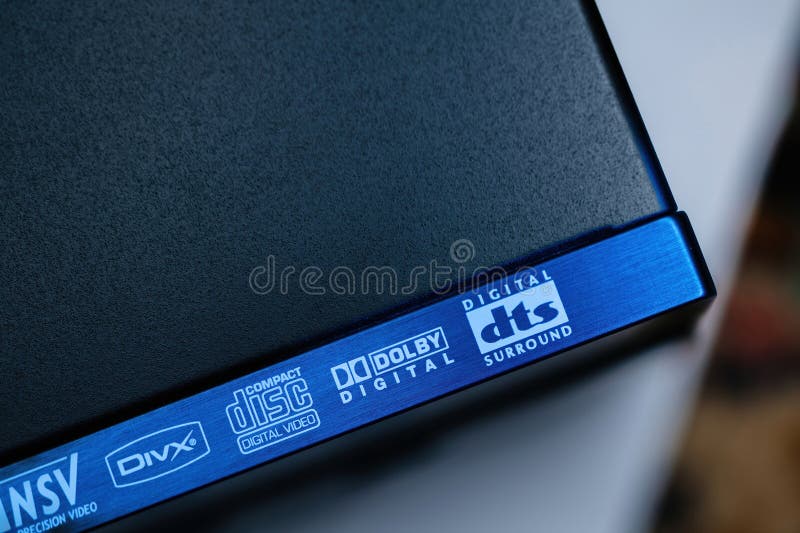 Hamburg, Germany - Feb 2, 2023: Close-up macro details of the steel surface of an Yamaha DVD SACD player with logotypes of DVIX, Compact Disk Digital Video, Dolby Digital and DTS surround. Hamburg, Germany - Feb 2, 2023: Close-up macro details of the steel surface of an Yamaha DVD SACD player with logotypes of DVIX, Compact Disk Digital Video, Dolby Digital and DTS surround