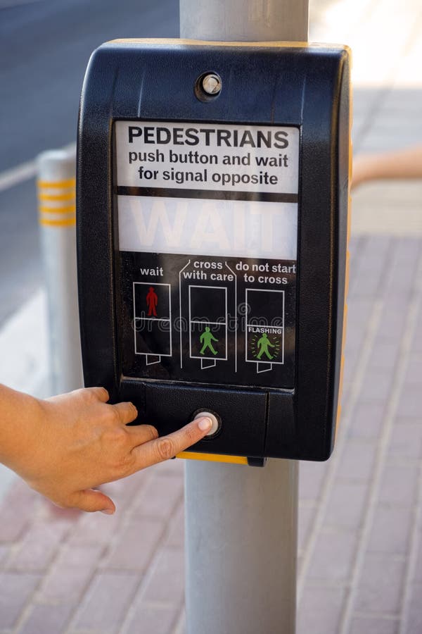 Woman finger pushing pedestrians button to cross the street. Woman finger pushing pedestrians button to cross the street.