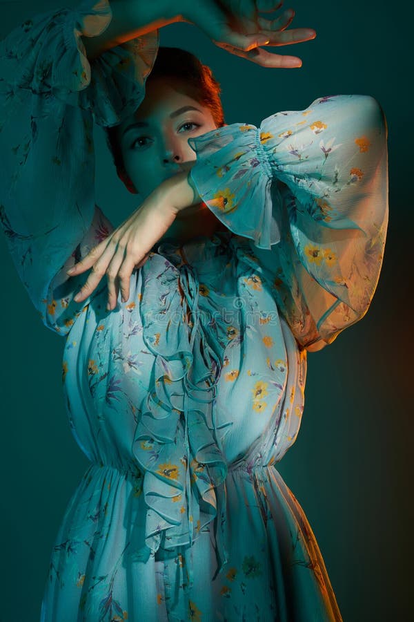 Fashion studio photo of young beautiful lady in blue chiffon dress on multi-colored background. Fashion and style. Fashion look book. Fashion studio photo of young beautiful lady in blue chiffon dress on multi-colored background. Fashion and style. Fashion look book