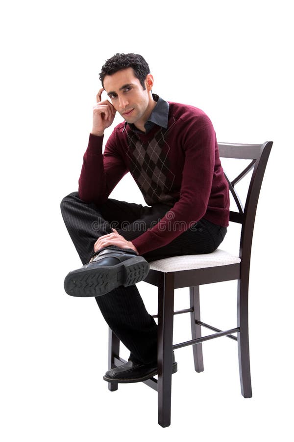 Handsome guy wearing business casual clothes sitting on a high chair and thinking, isolated. Handsome guy wearing business casual clothes sitting on a high chair and thinking, isolated