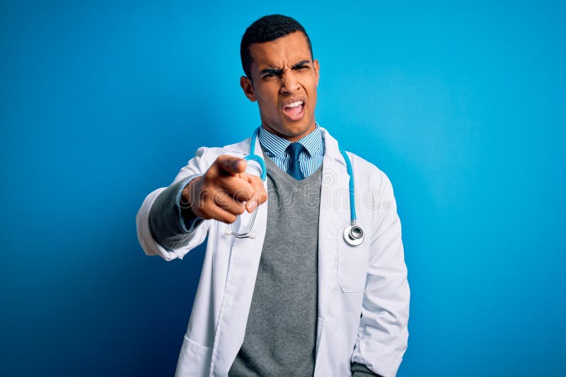 Handsome african american doctor man wearing coat and stethoscope over blue background pointing displeased and frustrated to the camera, angry and furious with you. Handsome african american doctor man wearing coat and stethoscope over blue background pointing displeased and frustrated to the camera, angry and furious with you