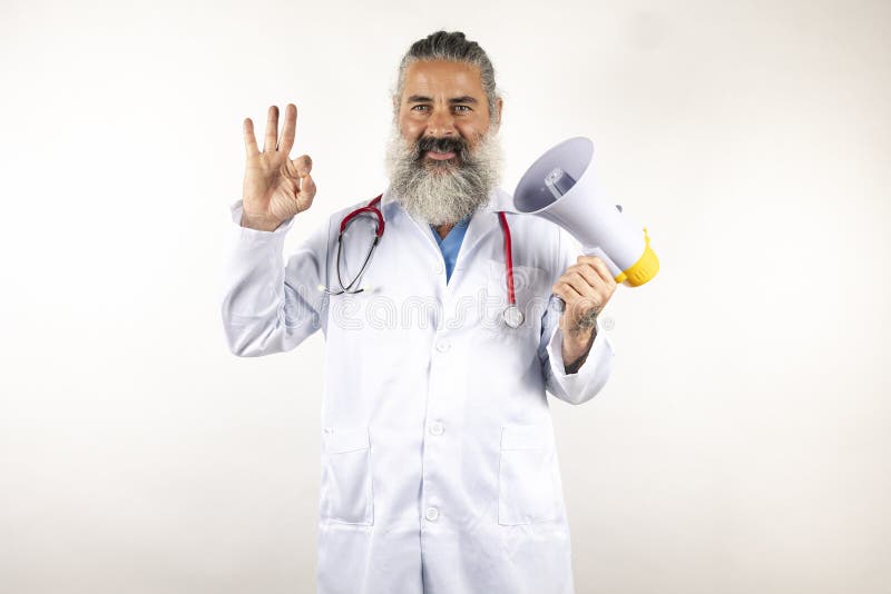 Handsome modern doctor with megaphone over isolated white background doing ok signwith fingers, excellent symbol . Handsome modern doctor with megaphone over isolated white background doing ok signwith fingers, excellent symbol .