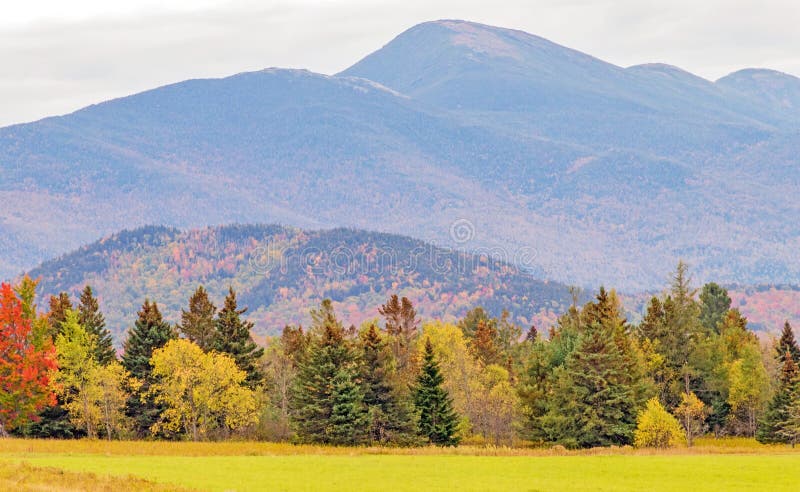 Mount Marcy and Adirondack Mountain high peaks area, Marcy Field at Adirondack Lodge entrance, Lake Placid New York, Autumn colors and tree line. Mount Marcy and Adirondack Mountain high peaks area, Marcy Field at Adirondack Lodge entrance, Lake Placid New York, Autumn colors and tree line