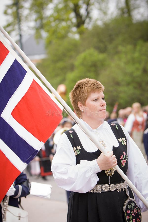 Oslo, Norway - May 17, 2010: National day in Norway. Norwegian woman in the national costume at traditional celebration and parade on Karl Johans Gate street. Oslo, Norway - May 17, 2010: National day in Norway. Norwegian woman in the national costume at traditional celebration and parade on Karl Johans Gate street.