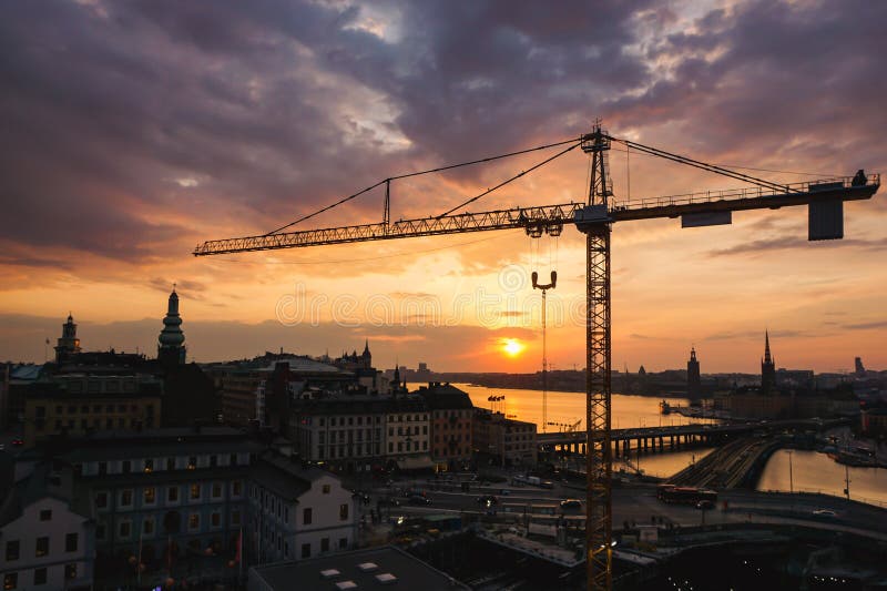 View of a construction crane over the city. View of a construction crane over the city