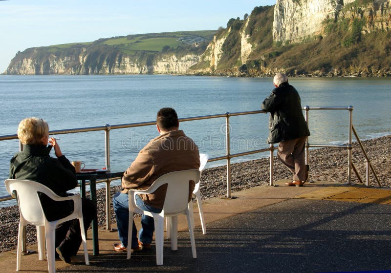 Relaxing with a coffee and a cigarette on the seafront promenade cafe at Seaton Devon. Relaxing with a coffee and a cigarette on the seafront promenade cafe at Seaton Devon