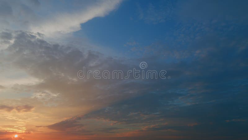 Timelapse. View of yellow sun setting in orange sky with dark clouds. Timelapse. View of yellow sun setting in orange sky with dark clouds.