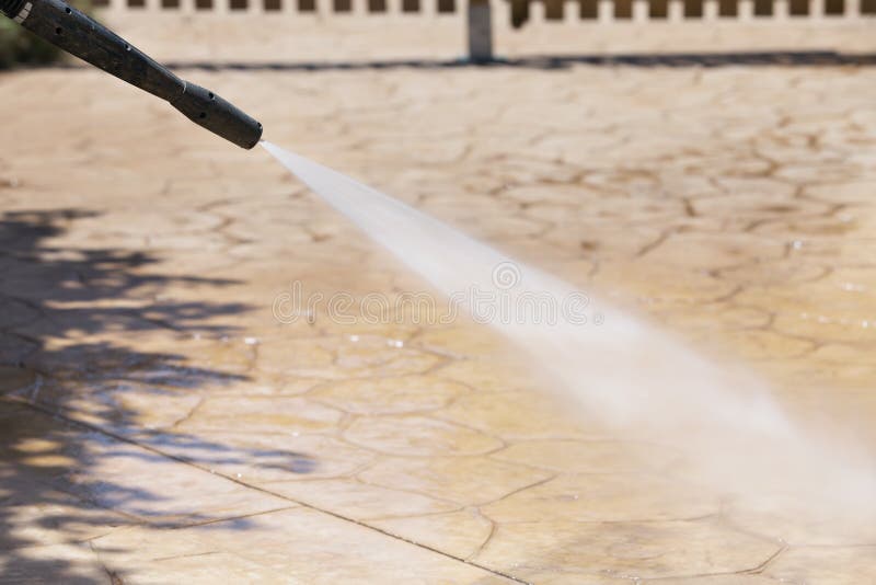 Cleaning the floor with water under pressure, closeup photo. Cleaning the floor with water under pressure, closeup photo