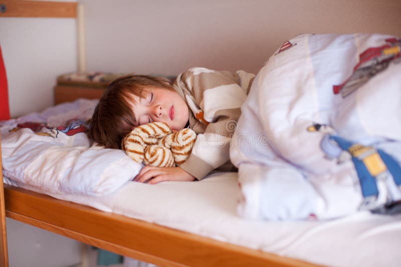 Cute little boy sleeping on bunk bed at hole. Cute little boy sleeping on bunk bed at hole