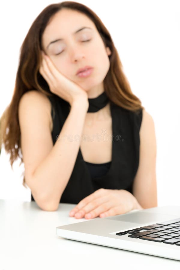 Tired caucasian business woman falling asleep in front of the computer. Tired caucasian business woman falling asleep in front of the computer.