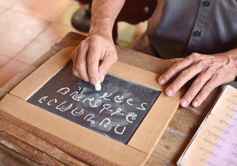 Hand Writing Thai Alphabet on Blackboard / Chalkboard. Hand Writing Thai Alphabet on Blackboard / Chalkboard