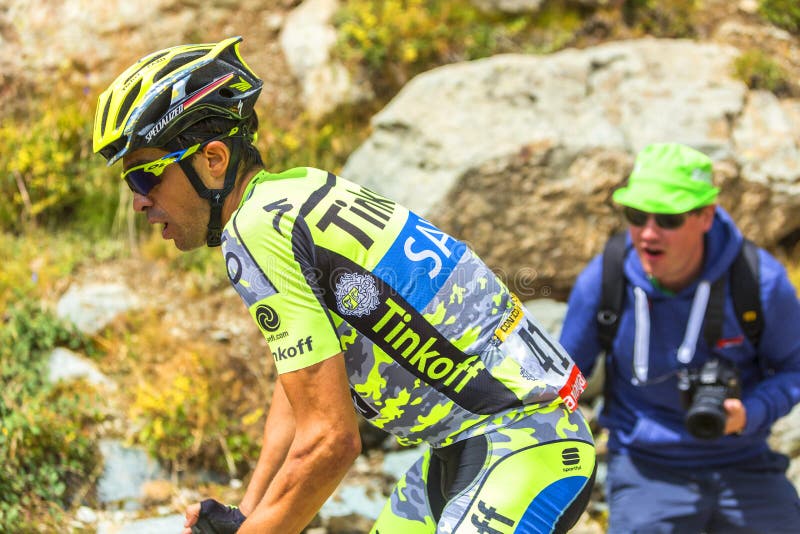 Col de la Croix de Fer, France - 25 July 2015: Profile of Alberto Contador of Thinkoff Saxo Team in full effort, climbing to the Col de la Croix de Fer in Alps during the stage 20 of Le Tour de France 2015. Col de la Croix de Fer, France - 25 July 2015: Profile of Alberto Contador of Thinkoff Saxo Team in full effort, climbing to the Col de la Croix de Fer in Alps during the stage 20 of Le Tour de France 2015.