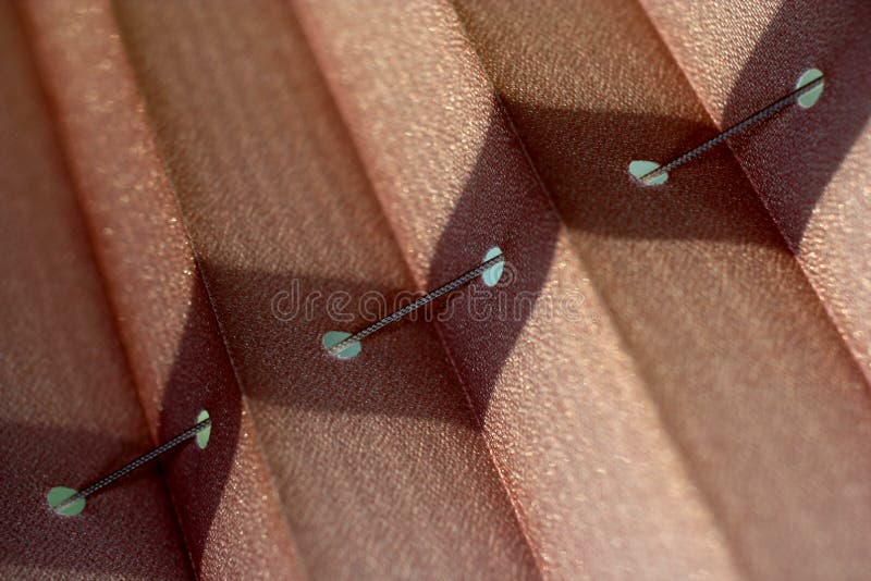 Macro of textured window blinds with string and holes making an abstract background. Macro of textured window blinds with string and holes making an abstract background.