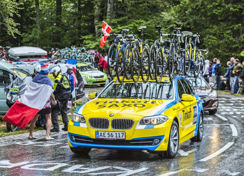 Le Markstein, France- July 13, 2014: The official car of the Team Saxo Thinkoff on the road to the mountain pass Le Markstein during the stage 9 of Le Tour de France 2014. Le Markstein, France- July 13, 2014: The official car of the Team Saxo Thinkoff on the road to the mountain pass Le Markstein during the stage 9 of Le Tour de France 2014.